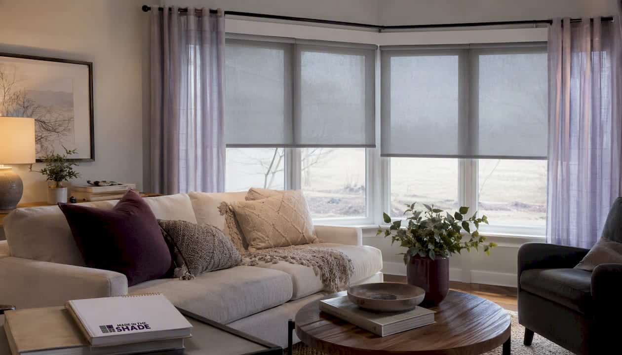 Living room window with roller shades and curtains layered
