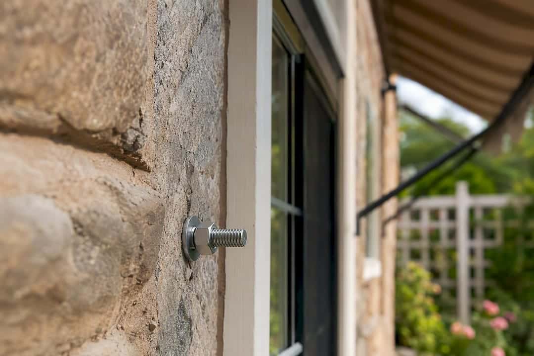 Anchored awning bolt in masonry wall