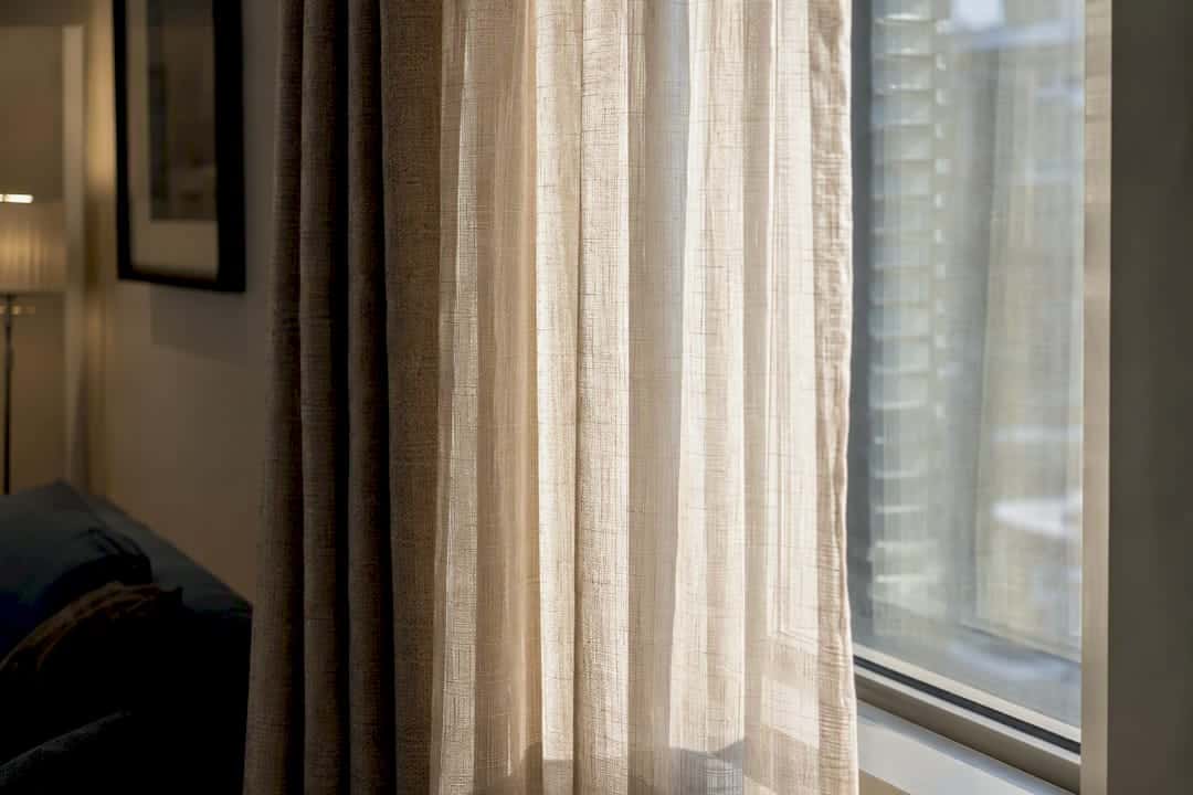 Layered light-filtering sheer and blackout fabrics