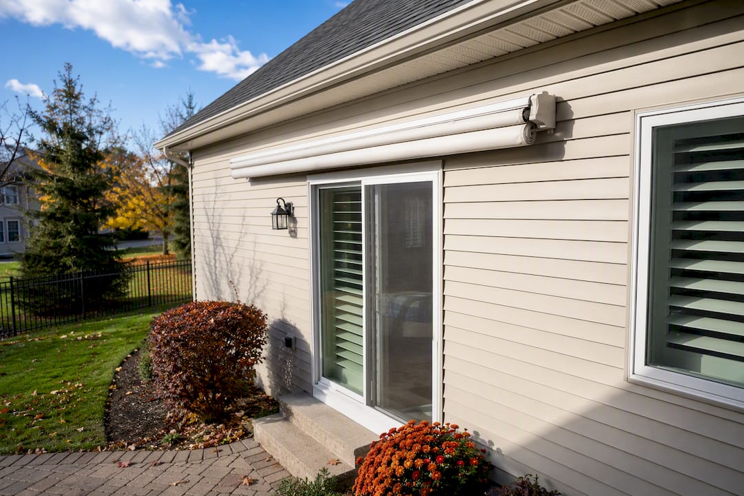 Retracted fabric awning on suburban home exterior