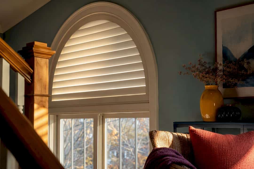 Custom covering fitted inside an arched window