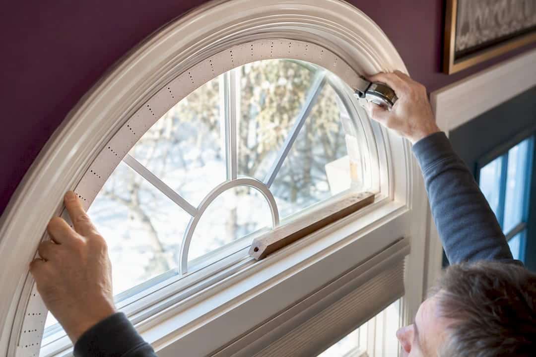 Template and tape measure on an arched window