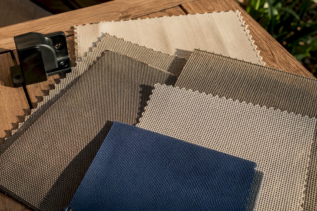 Outdoor shade fabric swatches in sunlight