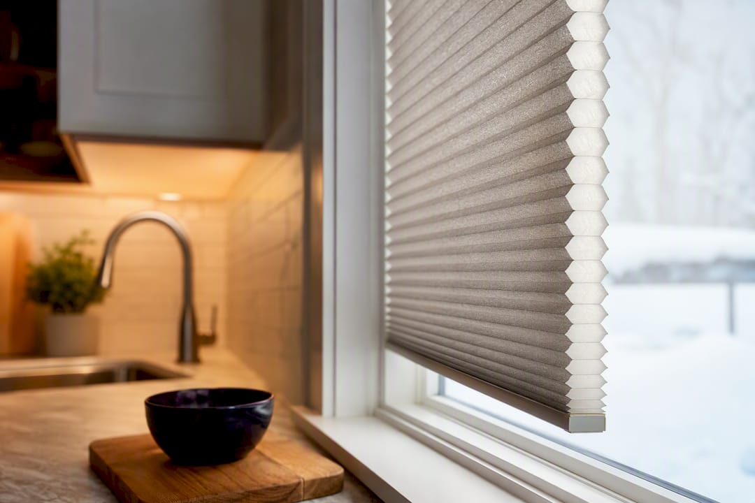 Cellular shade edge beside kitchen window