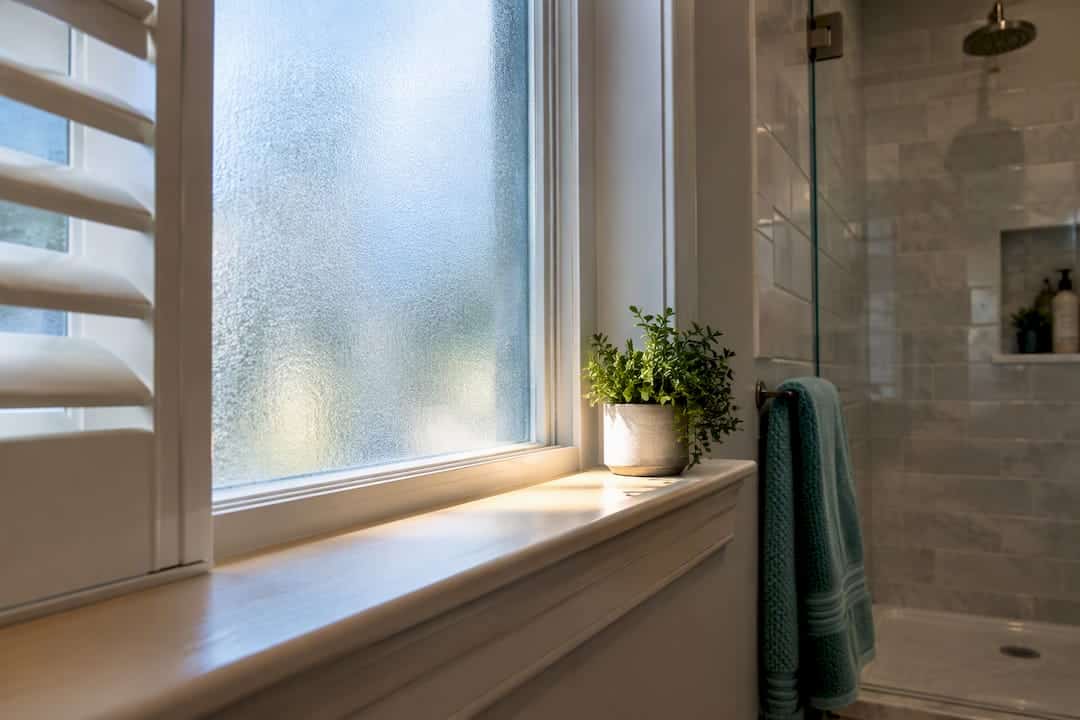 Frosted bathroom window with privacy shutter detail